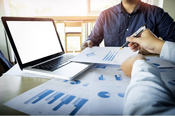 person pointing at data on a paper